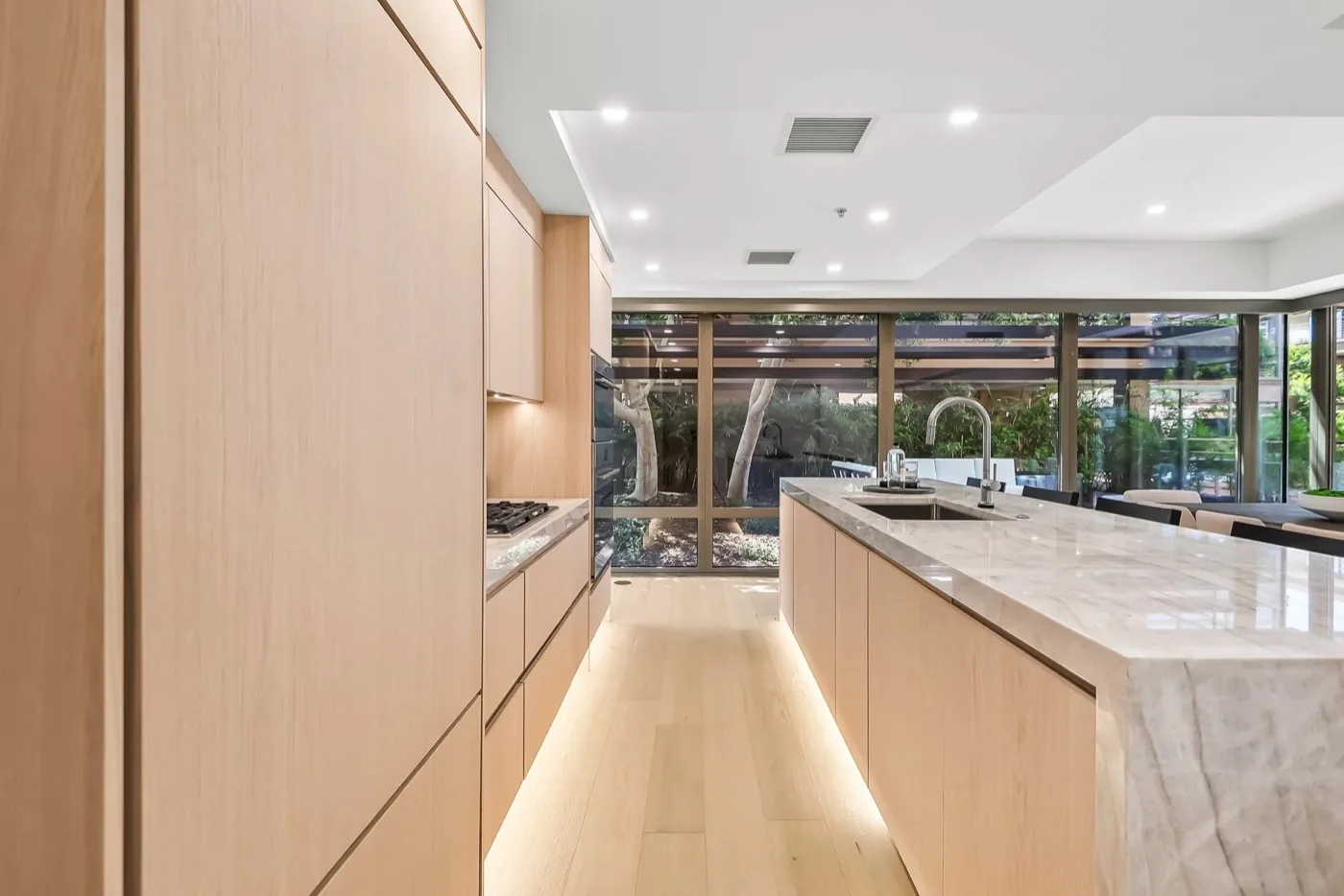 Rift oak kitchen cabinetry with stone island
